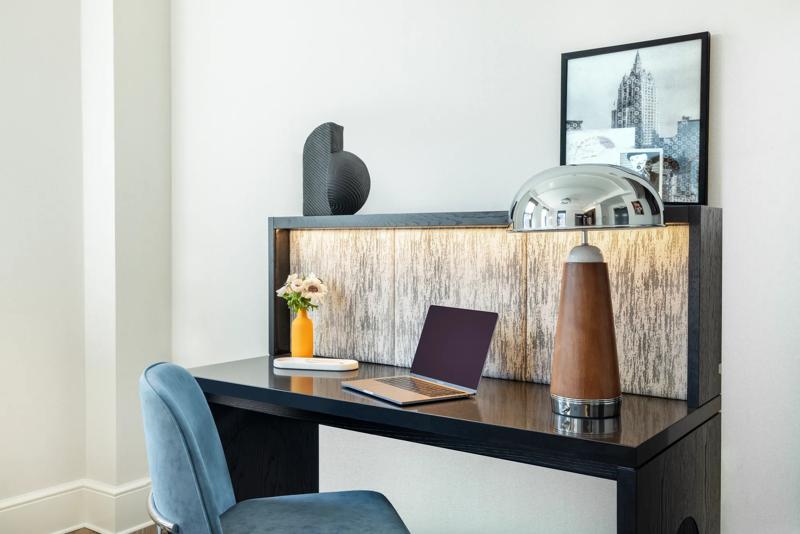 The work desk room amenities of a deluxe king studio suite