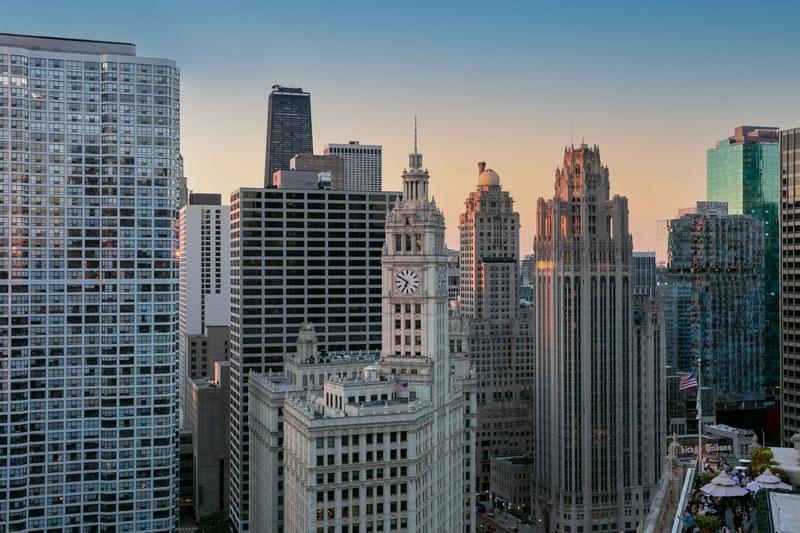 The full view out the window of the city clocktower at sunrise seen from Guest Rooms