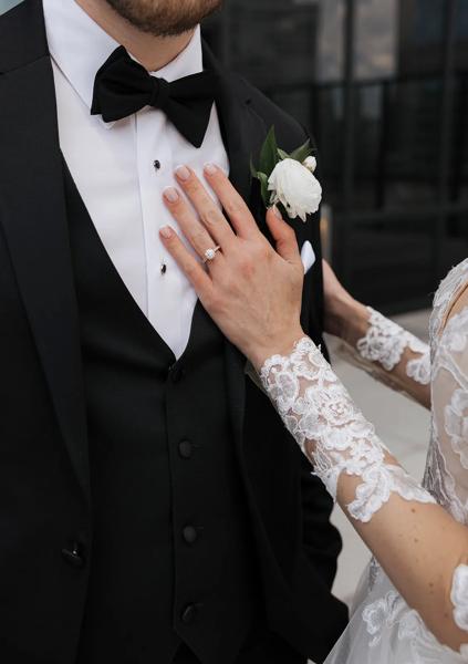 A bride placing her hand over her grooms heart