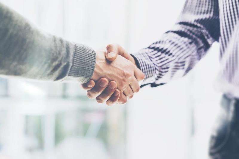 Business partnership meeting concept. Image businessmans handshake. Successful businessmen handshaking after good deal. Horizontal, blurred