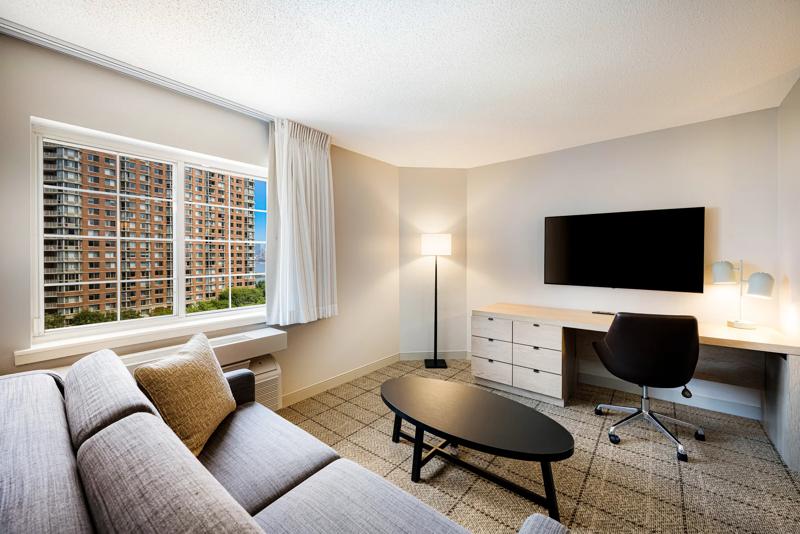 SIM_JerseyCity_GuestRooms_Harbor View_Seating_Curtains Open - 80F183EB-0F0C-4037-91FD5605A0A65208