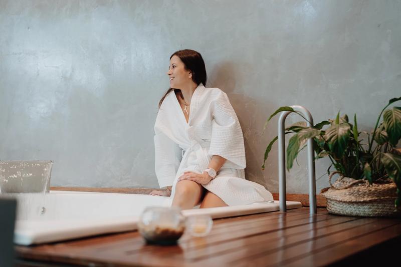 A guest enjoying the jacuzzi in her room
