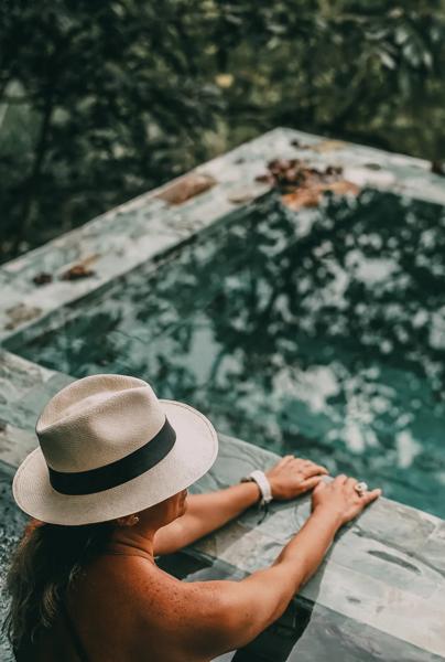 A guest lounging in one of the hotel pools