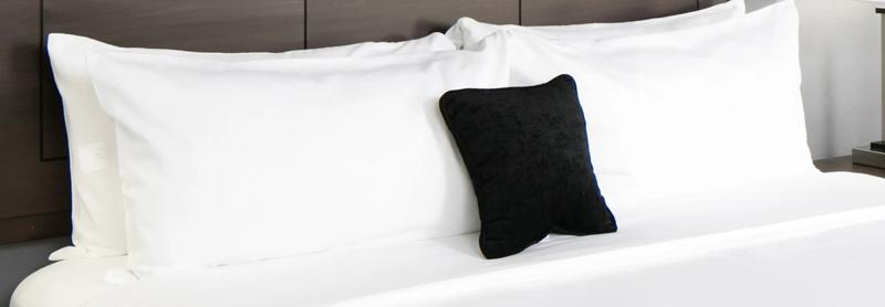 A cropped view of the bed in the hotel guest room