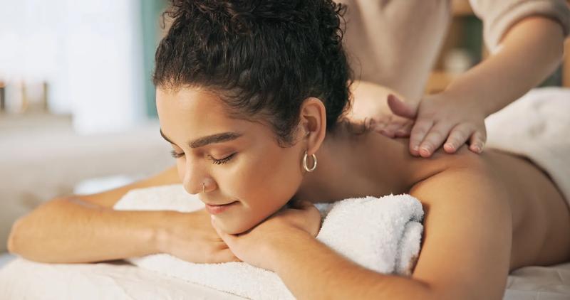 Spa, sleeping and massage for woman, rest and masseuse with client for therapy, health and gentle on back. Wellness, zen and hospitality for customer, people and treatment for body, relax and resort