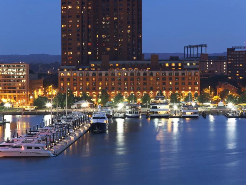 A view from the harbor of the facade of the Royal Sonesta lit up at night