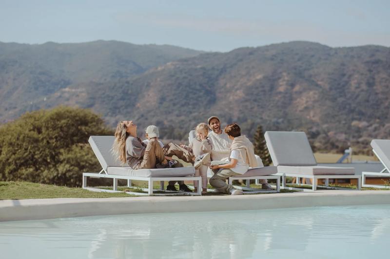 A family sitting poolside enjoying their time together