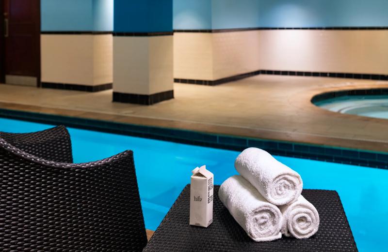 A close up of towel and a boxed water by the hotel pool