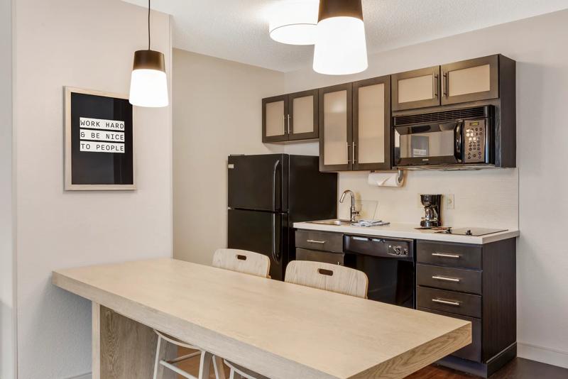 Angled view of dining space and kitchen with appliances
