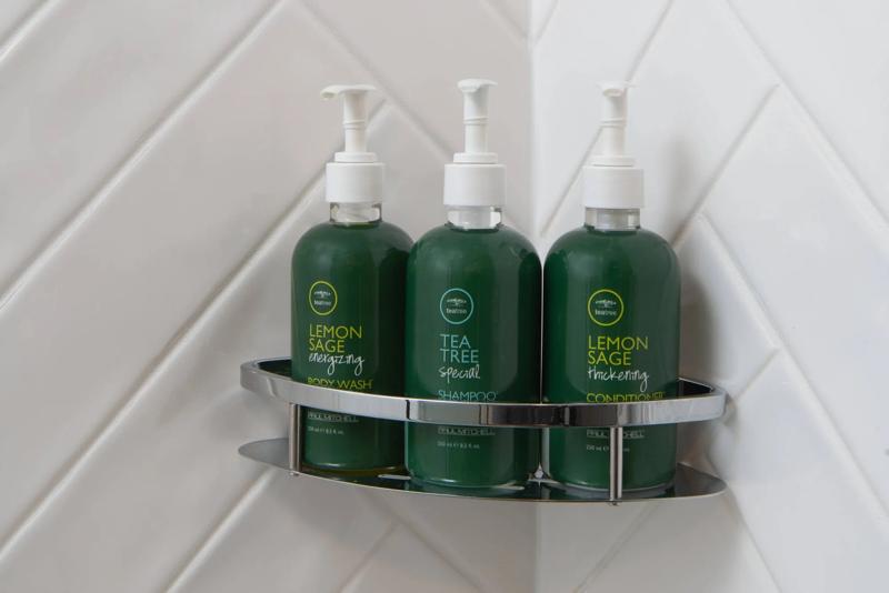 Bathroom amenities including Paul Mitchell Tea Tree toiletries